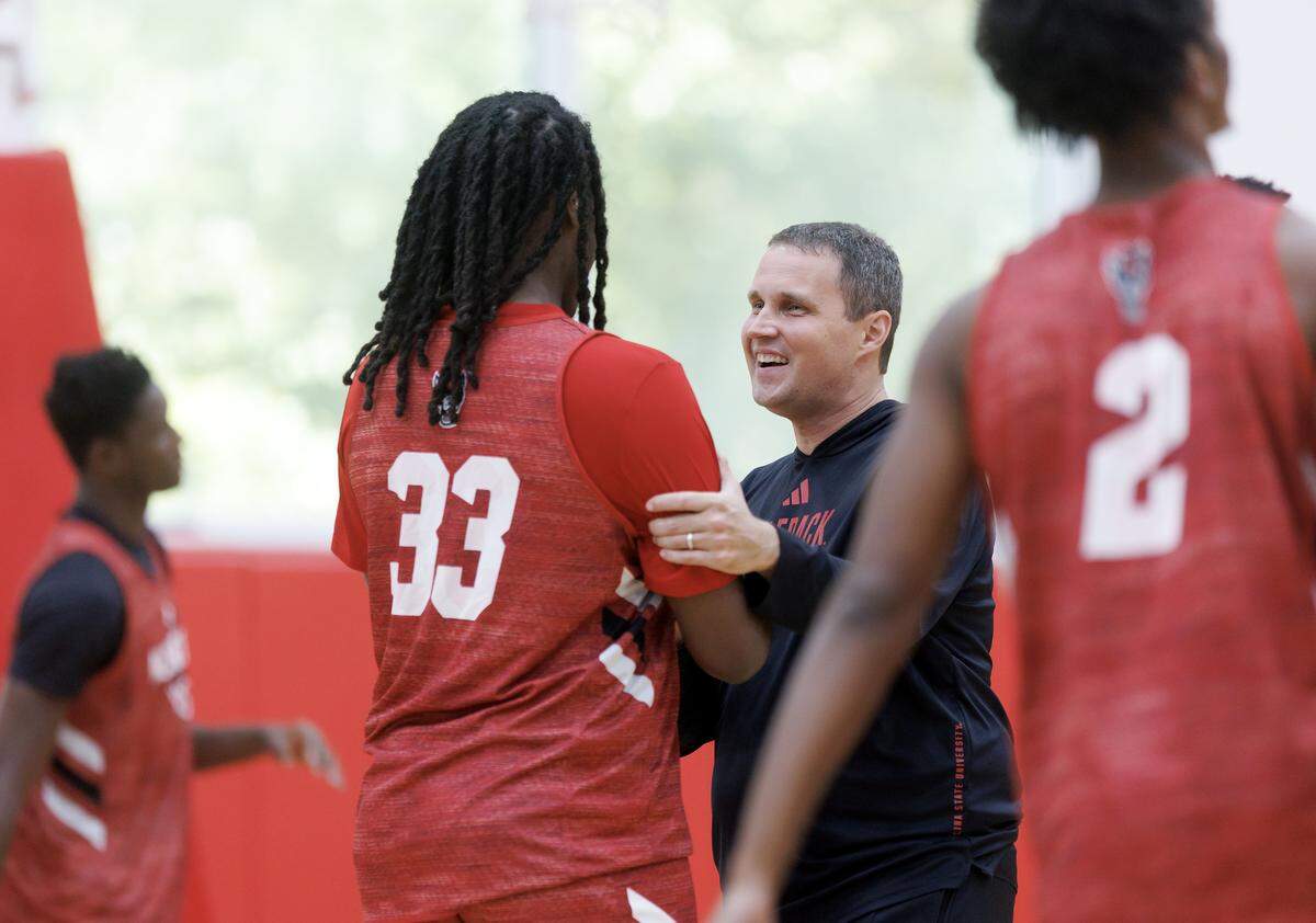 N.C. State head coach Will Wade greets Zymicah Williams at the start of the team’s first official practice on Monday, Sept. 22, 2025, in Raleigh, N.C. at Dail Basketball Center.