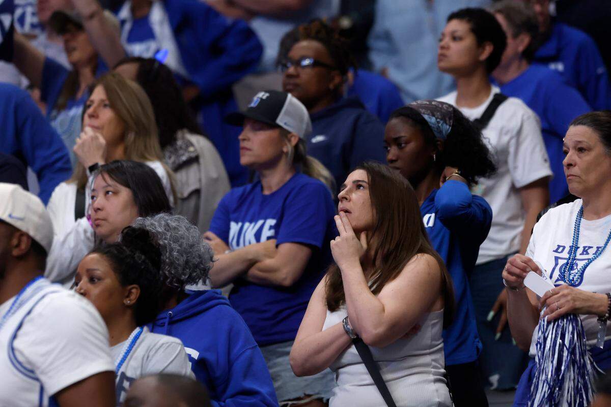 Duke fans react during an official review to determine possession during the final minute of the Blue Devils’ 54-50 loss to South Carolina in the NCAA Tournament Elite Eight at Legacy Arena on Sunday, March 30, 2025, in Birmingham, Ala.