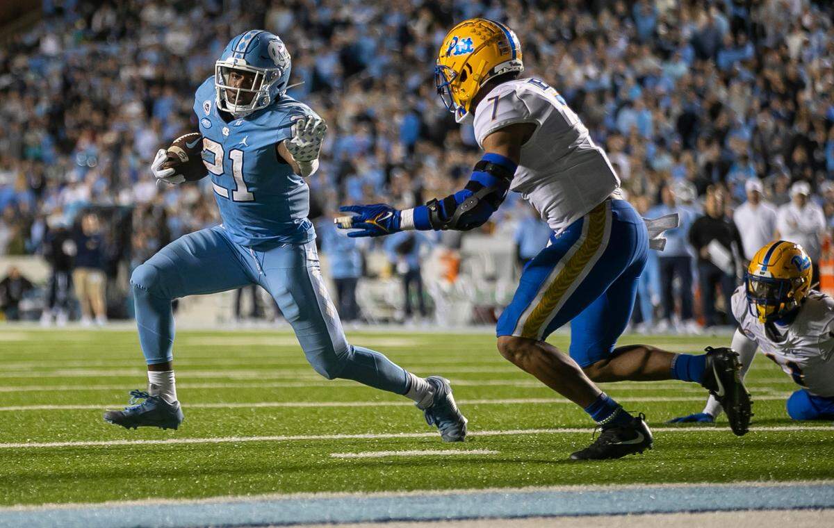 North Carolina’s Elijah Green (21) scores the game winning touchdown on a two yard run to give the Tar Heels’ 28-24 lead in the fourth quarter against Pitt on Saturday, October 29, 2022 at Kenan Stadium in Chapel Hill, N.C.