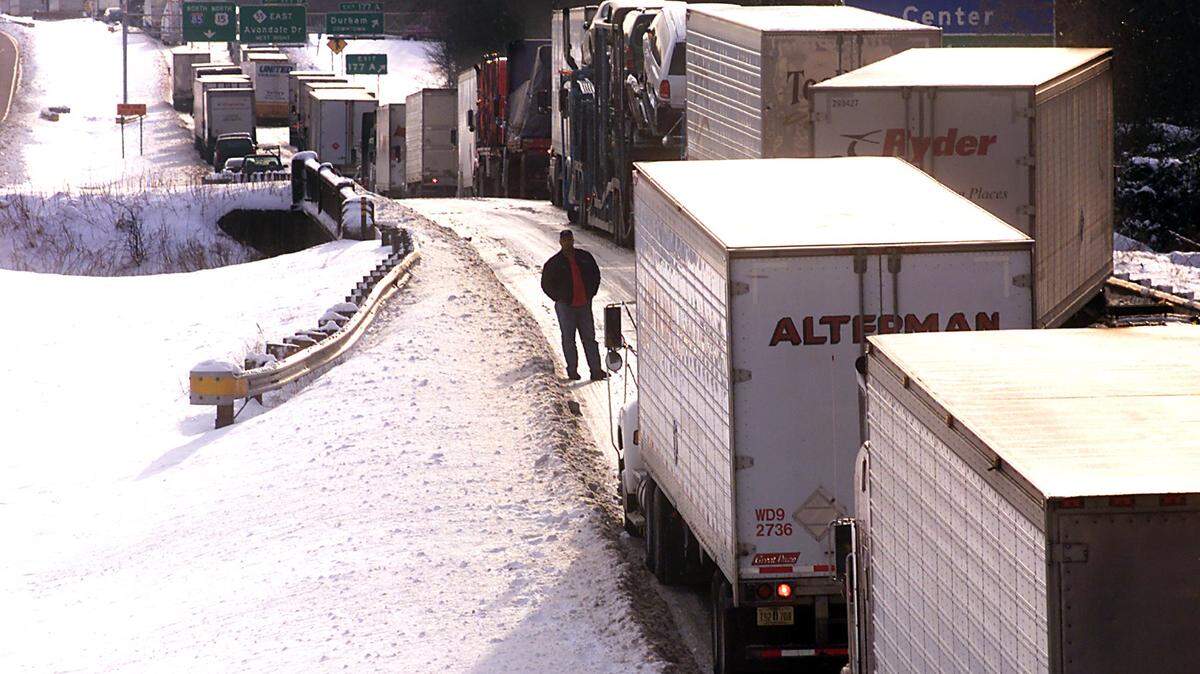 A truck driver stands in front of his rig and looks back at the traffic snarled along Interstate 85 in Durham in 2000.