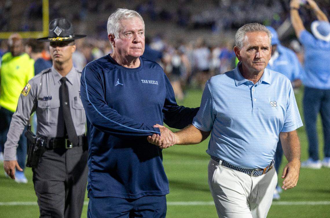 North Carolina coach Mack Brown shakes hands with Athletic Director Bubba Cunningham, as they leave the field together, following the Tar Heels’ 21-20 loss to Duke on Saturday, September 28, 2024 at Wallace Wade Stadium in Durham, N.C.