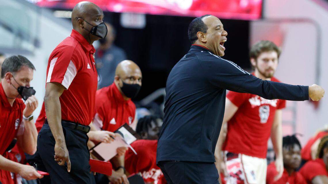 N.C. State assistant coach James Johnson, left, stand behind head coach Kevin Keatts during the Wolfpack’s game against Syracuse at PNC Arena in Raleigh, N.C., Wednesday, Feb. 2, 2022.