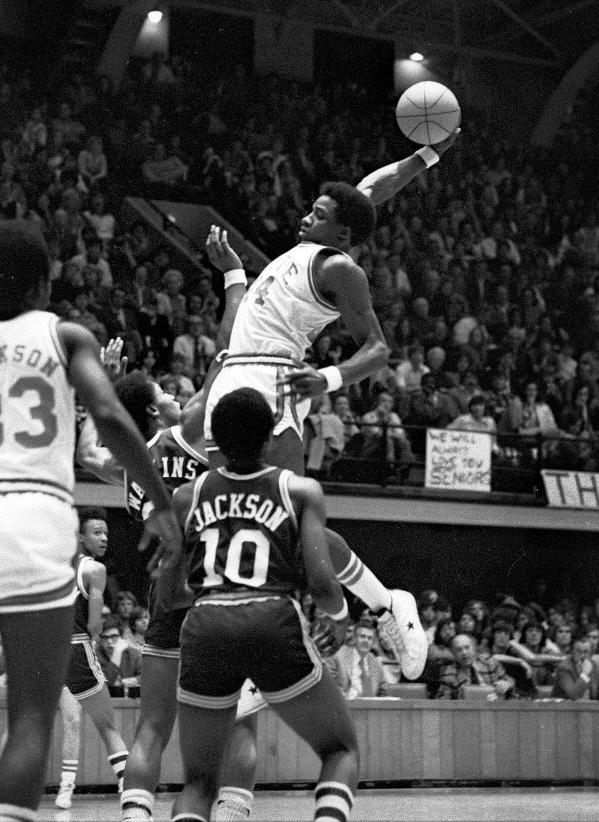 NC State’s David Thompson soars through the air during his final home game in Reynolds Coliseum against UNC-Charlotte on March 2, 1975.