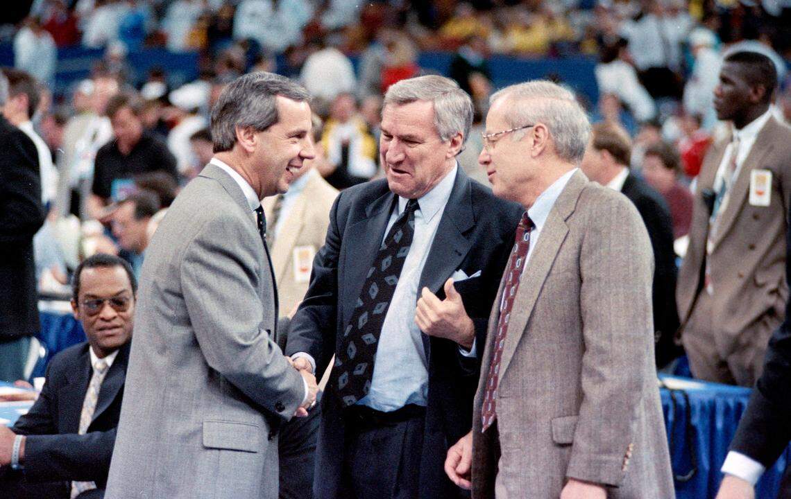 Coaches Roy Williams (left), then at Kansas, Dean Smith and assistant coach Bill Guthridge talk before the Tar Heels faced the Jayhawks at the 1993 Final Four in New Orleans.