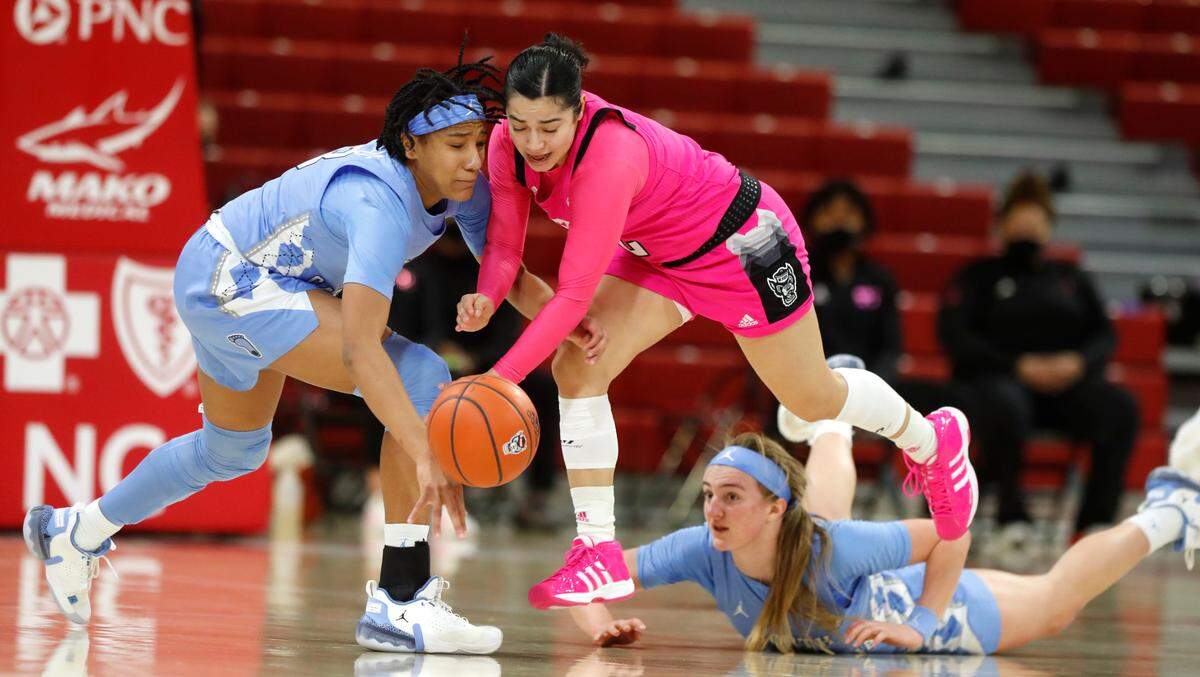 N.C. State’s Raina Perez (2) keeps the ball from North Carolina’s Kennedy Todd-Williams (3) after stealing the ball during the first half of N.C. State’s game against UNC in the annual Play4Kay game at Reynolds Coliseum in Raleigh, N.C., Sunday, February 21, 2021.