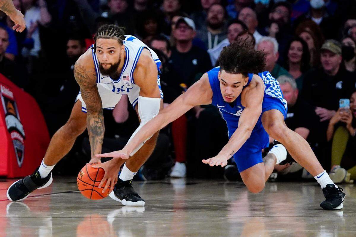 Duke’s Theo John, left, fights for control of the ball with Kentucky’s Lance Ware, right, during the first half of an NCAA college basketball game Tuesday, Nov. 9, 2021, in New York.