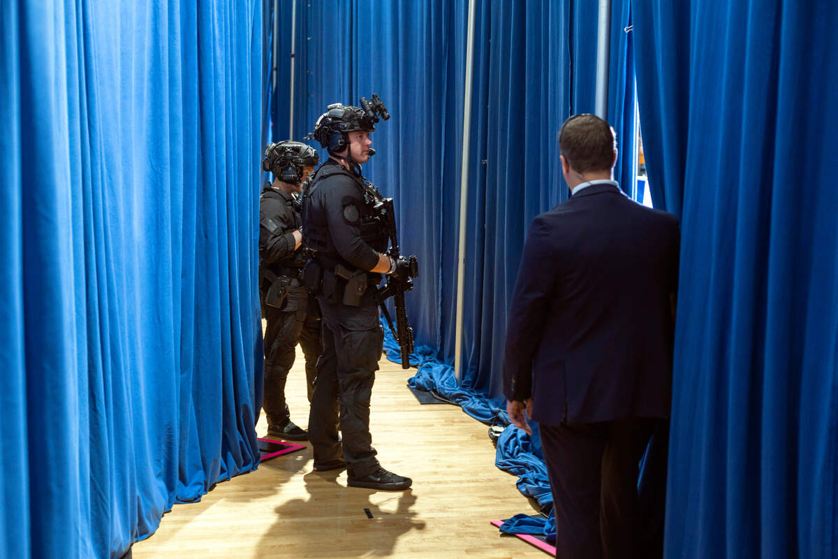 Security detail armed with long guns, stand backstage behind Vice President Kamala Harris as she delivers remarks during a campaign rally at Westover High School on Thursday, July 18, 2024 in Fayetteville, N.C.