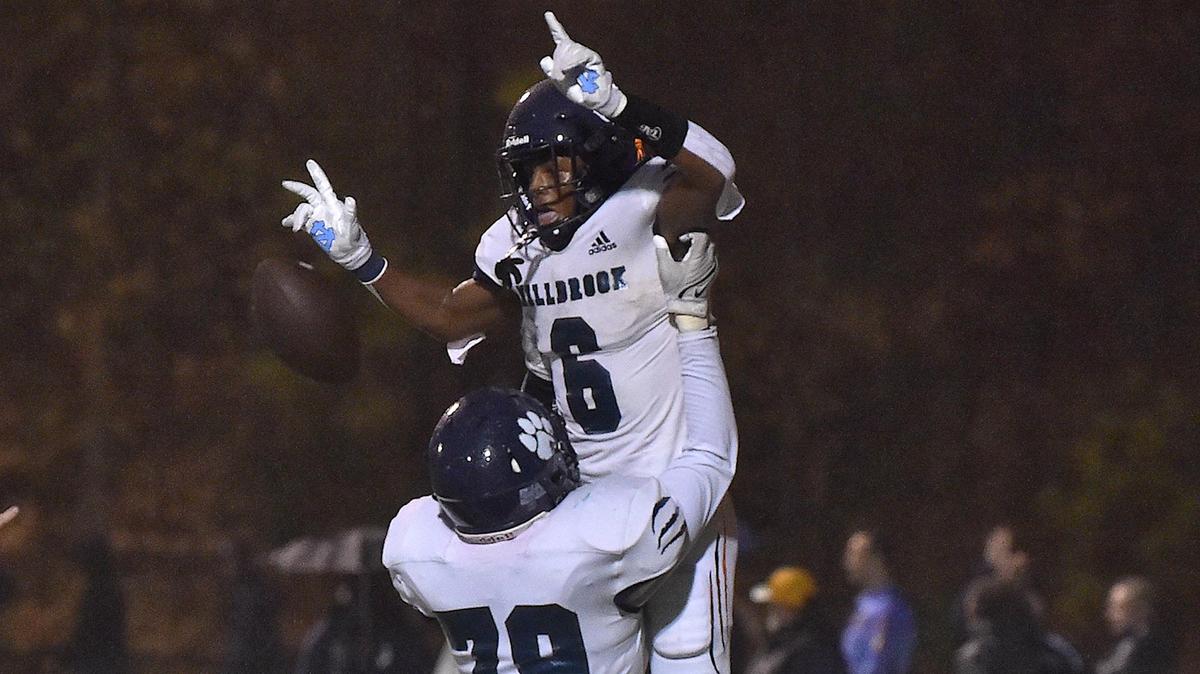 Millbrook’s Tyler Hill (79) hosts uo and celebrates with Xavier Pugh (6) after his touchdown in the second half. The Cardinal Gibbons Crusaders and the Millbrook Wildcats met in a NCHSAA 4A playoff game in Raleigh, NC on November 10, 2022