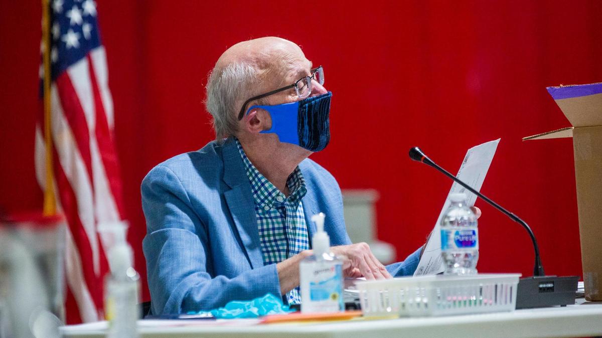 Gerry Cohen, Wake County Board of Elections Board member, reviews absentee ballots during a board meeting at the Board of Elections Operations Center, on Tuesday, Sep. 29, 2020, in Raleigh, N.C.