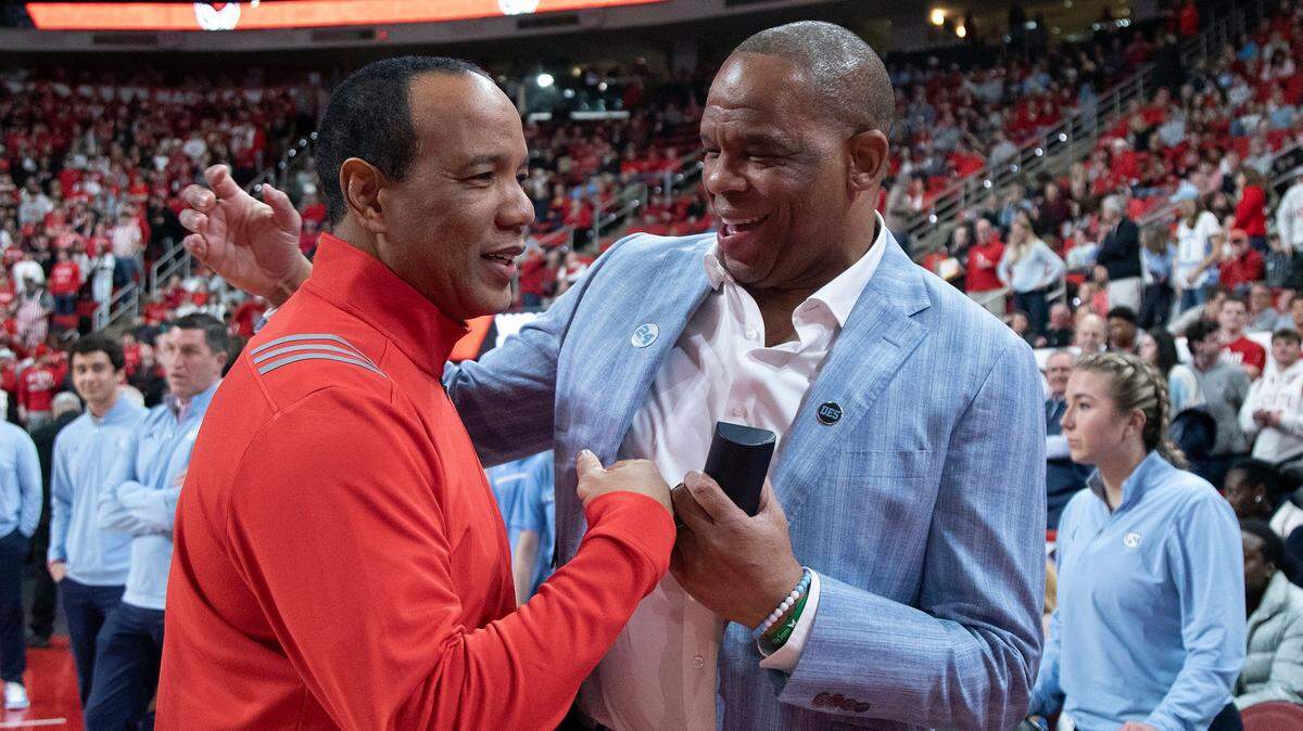 N.C. State head coach Kevin Keatts and North Carolina head coach Hubert Davis share a laugh prior to their game on Saturday, Jan. 11, 2025, at Lenovo Center in Raleigh, N.C.