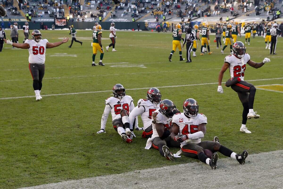 Tampa Bay Buccaneers celebrate after recovering a fumble by Green Bay Packers’ Aaron Jones (33) after being hit by Tampa Bay Buccaneers’ Jordan Whitehead (33) during the second half of the NFC championship NFL football game in Green Bay, Wis., Sunday, Jan. 24, 2021.
