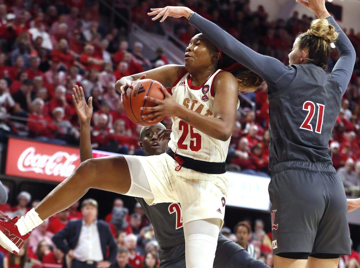 N.C. State’s Kayla Jones (25) pulls in a rebound from Louisville’s Kylee Shook (21) during the second half of Louisville’s 66-59 victory over N.C. State at Reynolds Coliseum in Raleigh, N.C., Thursday, Feb. 13, 2020.
