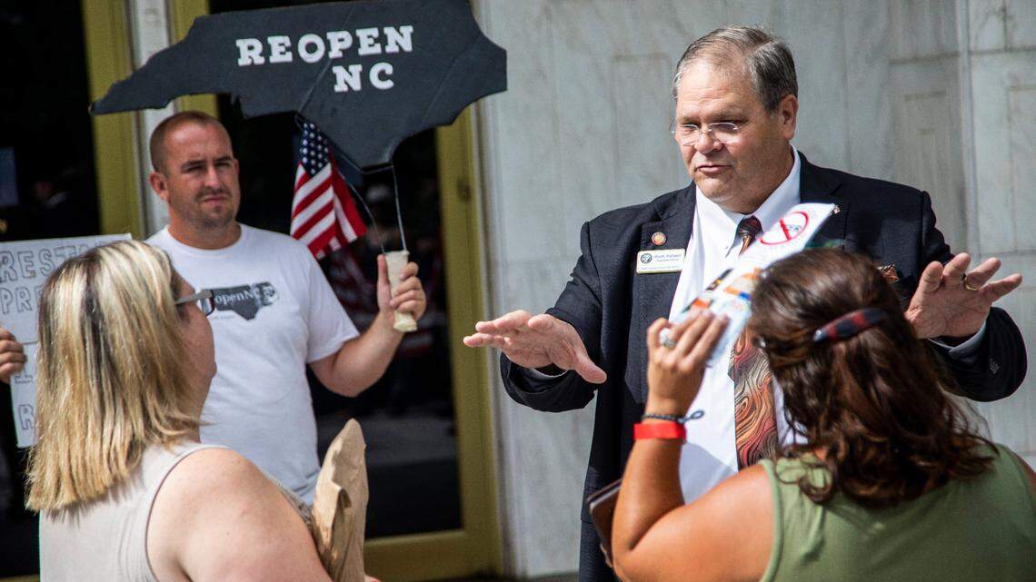 In this 2020 file photo, state Rep. Keith Kidwell talks with Reopen NC demonstrators. In an effort to cast doubt on the 2020 election, Kidwell is now seeking a new audit of N.C. voting machines. The State Board of Elections says the election results were certified and Kidwell is spreading misinformation.