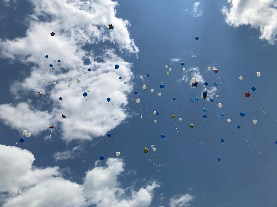 Balloons released by the friends and family of Paulette Thorpe fly above her memorial at Beechwood Cemetery in Durham on Sunday, July 4, 2021.