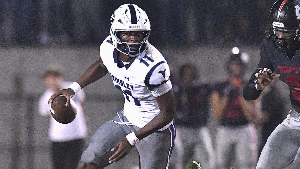 Grimsley quarterback Faizon Brandon (11) looks to pass while pursued by Rolesville’s Zavion Griffin-Haynes (9) during the first half. The Rolesville Rams and the Greensboro Grimsley Whirlies met in a non-conference football game in Rolesville, N.C. on August 30, 2024.