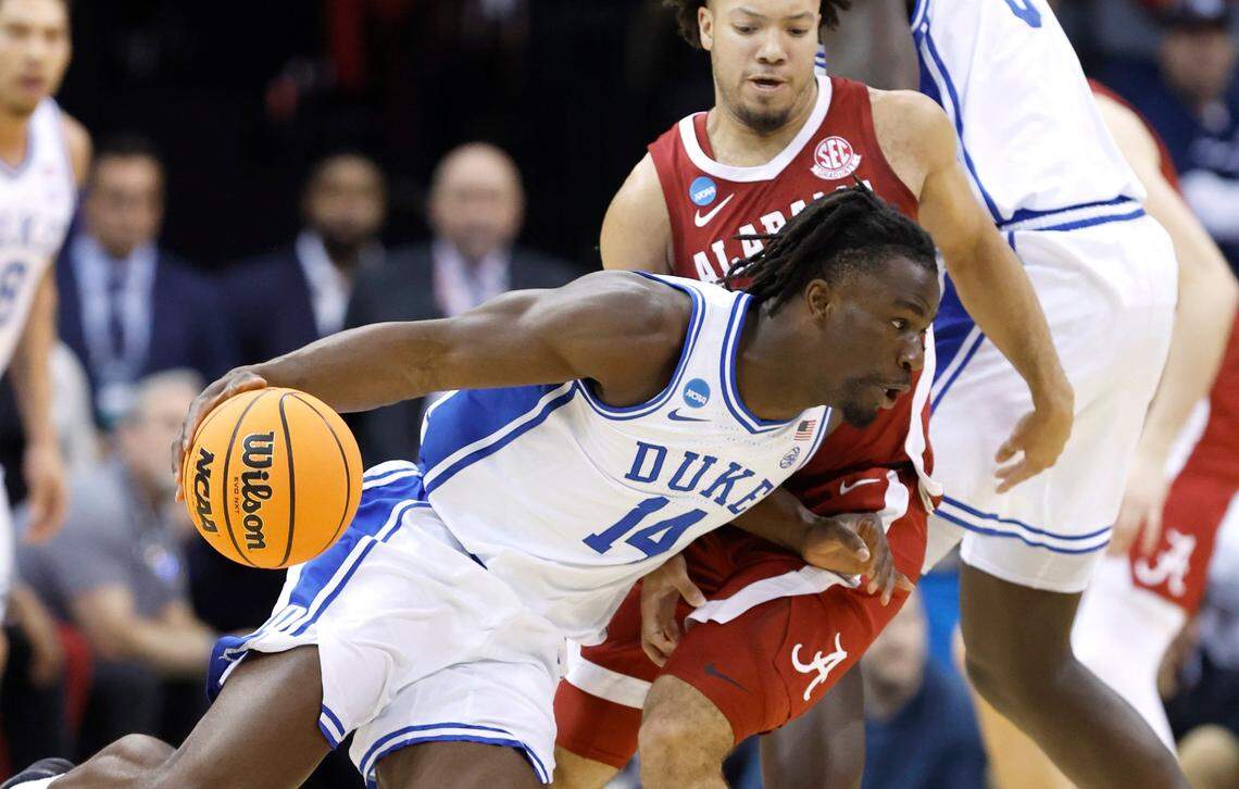 Duke’s Sion James (14) drives around Alabama’s Mark Sears (1) during the first half of Duke’s game against Alabama in their Elite 8 game in the 2025 NCAA Men’s Basketball Championship at the Prudential Center in Newark, N.J., Saturday, March 29, 2025.