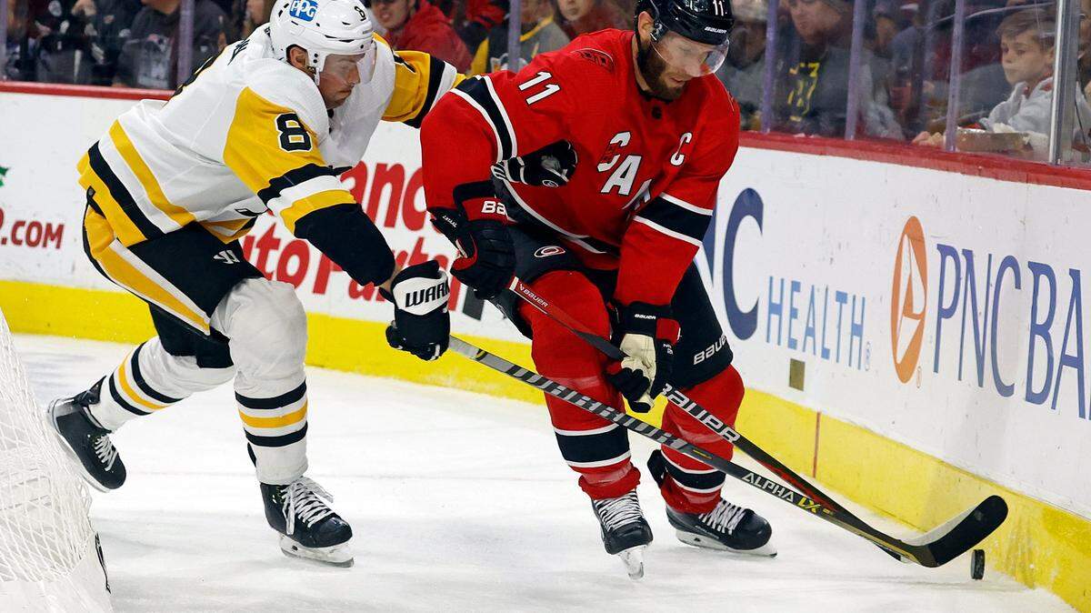 Carolina Hurricanes’ Jordan Staal (11) protects the puck from Pittsburgh Penguins’ Brian Dumoulin (8) during the second period of an NHL hockey game in Raleigh, N.C., Sunday, Dec. 18, 2022. (AP Photo/Karl B DeBlaker)
