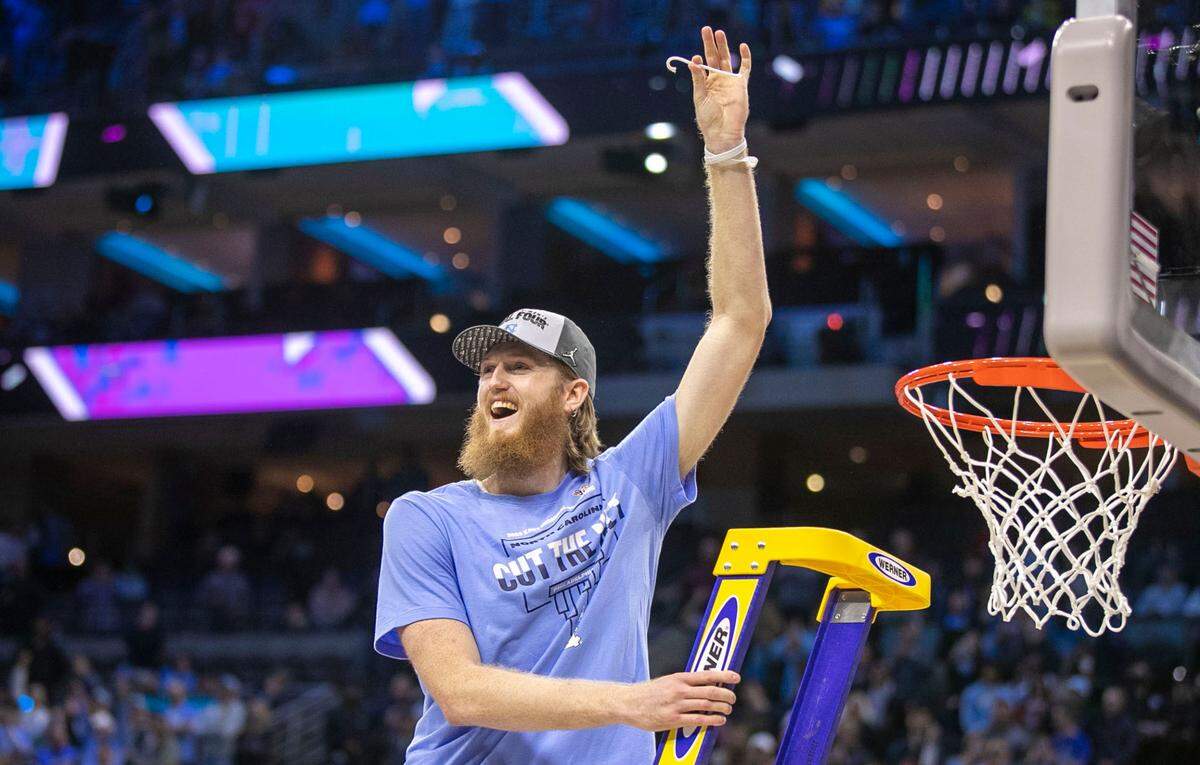 North Carolina’s Brady Manek (45) cuts down the net following their 69-49 victory over Saint Peter’s in the NCAA East Regional Championship game on Sunday, March 27, 2022 at Wells Fargo Center in Philadelphia, Pa.
