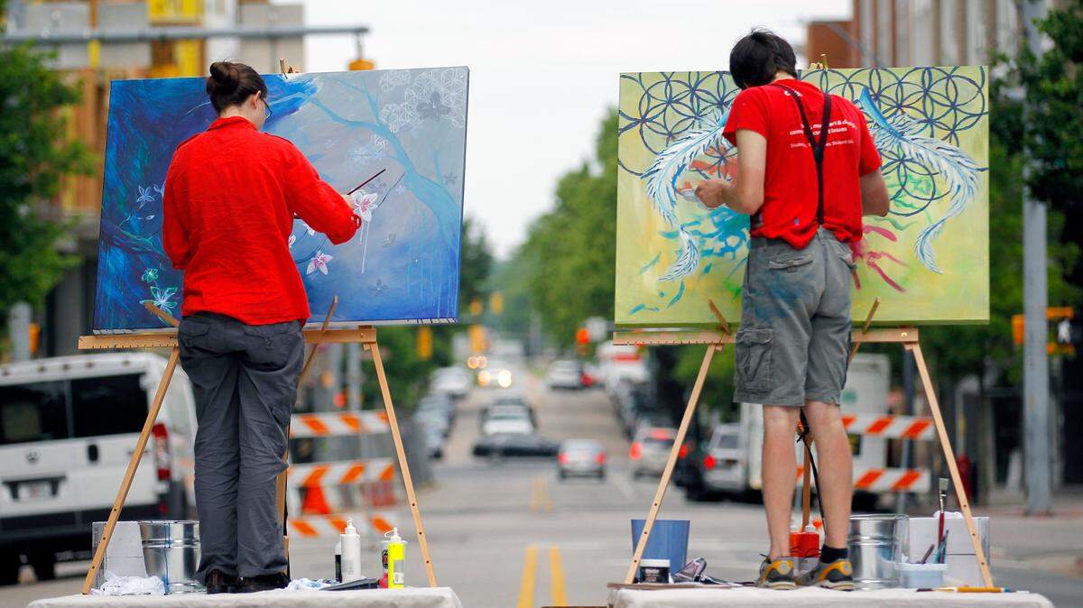 Artists fill the streets of downtown Raleigh during Artsplosure, Raleigh’s annual spring arts festival. In addition to artists selling their works, there is participatory art on the streets, street performers and stage shows and bands.