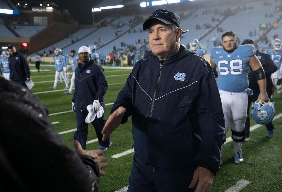 North Carolina coach Mack Brown shakes hands with Mercer coach Bobby Lamb following the Tar Heels’ 56-7 win on Saturday, November 23, 2019 at Kenan Stadium in Chapel Hill, N.C.
