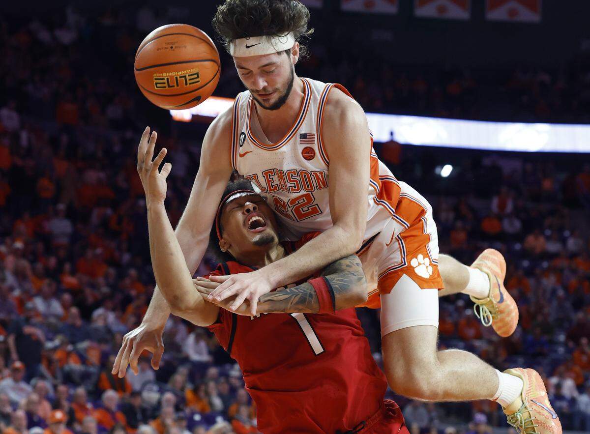 Clemson's Carter Welling (22) fouls N.C. State's Darrion Williams (1) during the second half of N.C. State’s 80-76 overtime victory over Clemson at Littlejohn Coliseum in Clemson, S.C., Tuesday, Jan. 20, 2026.