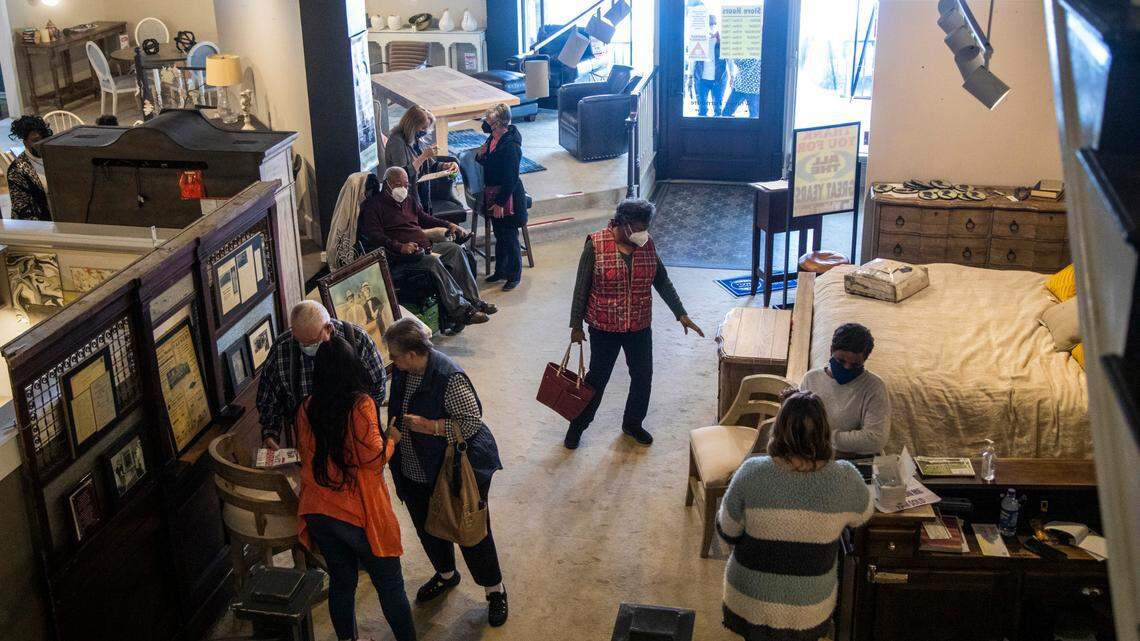 Customers shop at Whitley Furniture Gallery in downtown Zebulon Tuesday, Jan. 25, 2022. The store is going out of business after four generations of family operation and the city block it covers will likely be redeveloped.