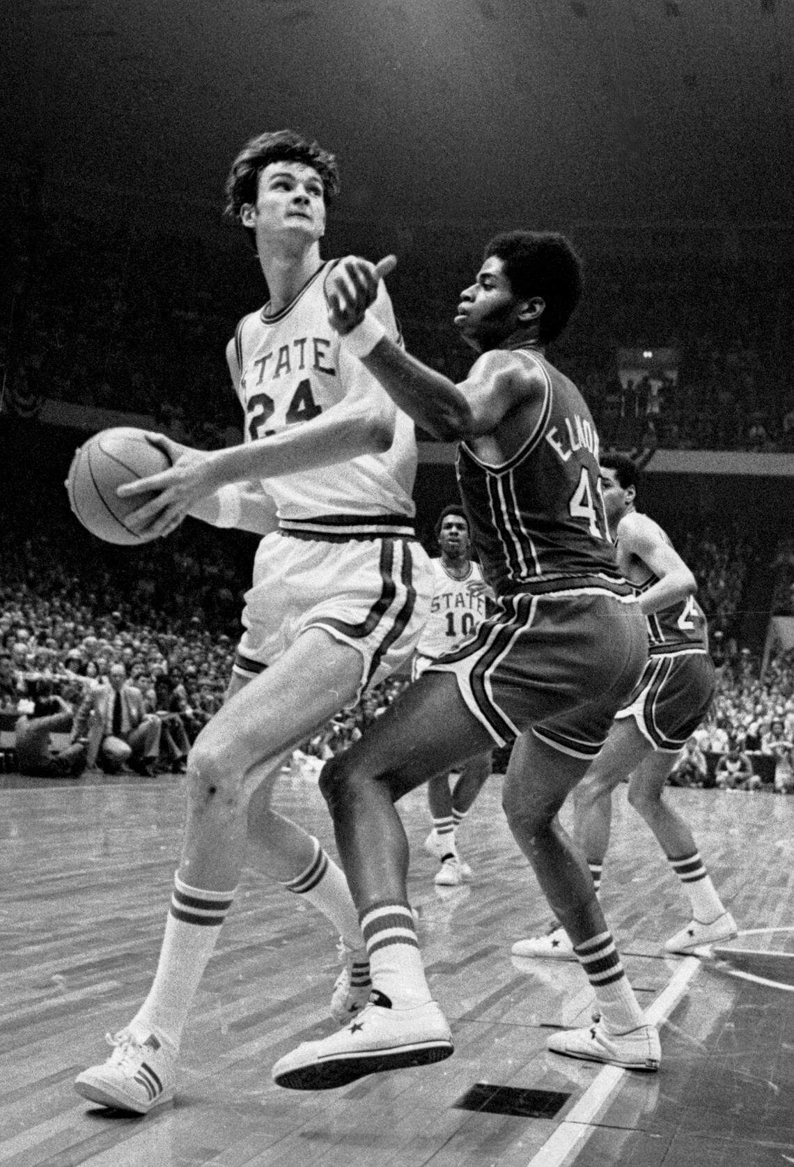 NC State center Tommy Burleson drives against Maryland center Len Elmore in the 1974 ACC Tournament championship game.