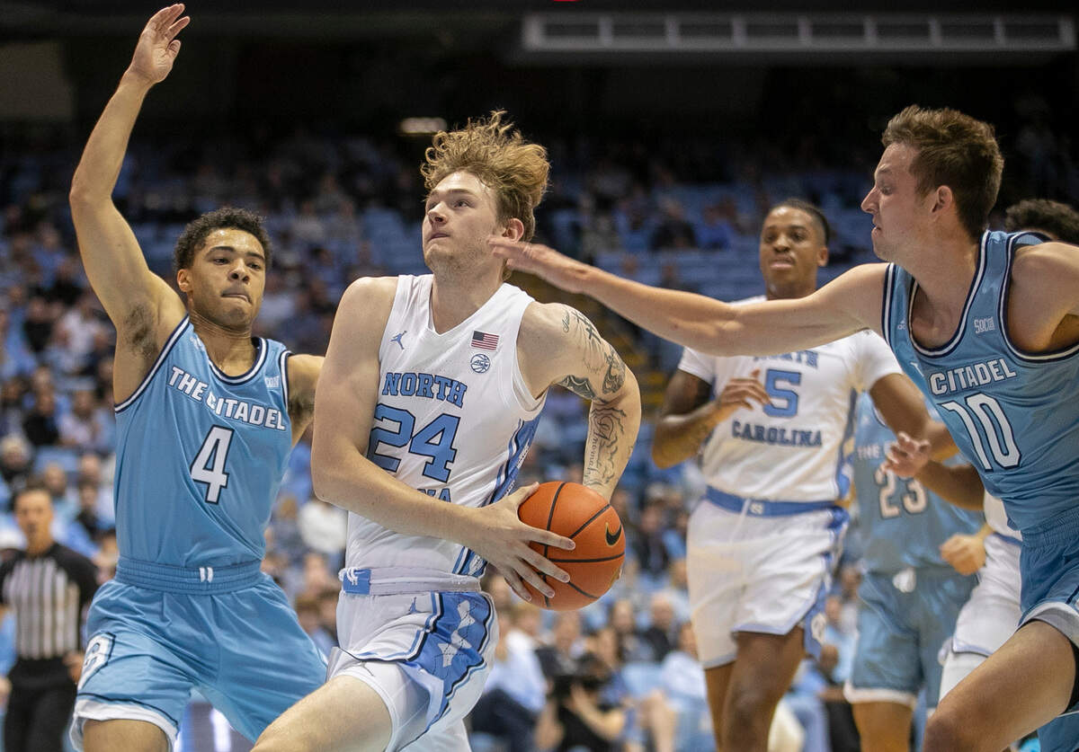 North Carolina’s Tyler Nickel (24) drives to the basket between The Citadel’s Elijah Morgan (4) and Austin Ash (10) in the first half on Tuesday, December 13, 2022 at the Smith Center in Chapel Hill, N.C.