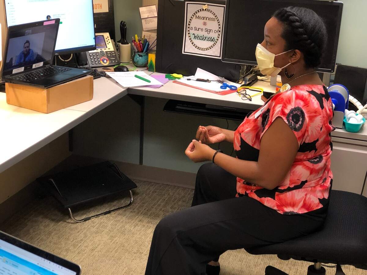 Heather Davis, a voice therapist at UNC, teaches breathing exercises to new patient Alyx Ashby of Newton to help Ashby recover from long COVID-19.  