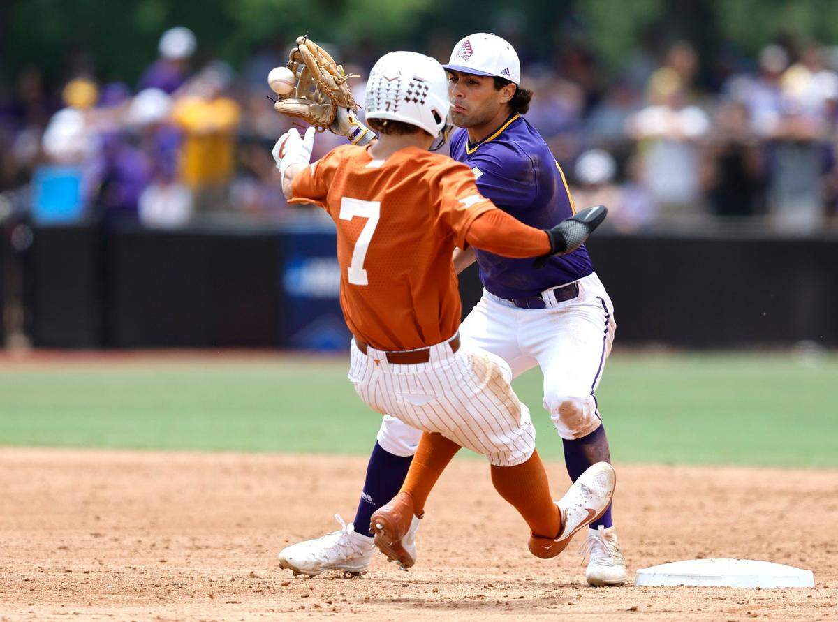 East Carolina’s Zach Agnos (14) gets ready to tag out Texas’ Douglas Hodo (7) during ECUs game against Texas in the Greenville Super Regional at Clark-LeClair Stadium Saturday, June 11, 2022.