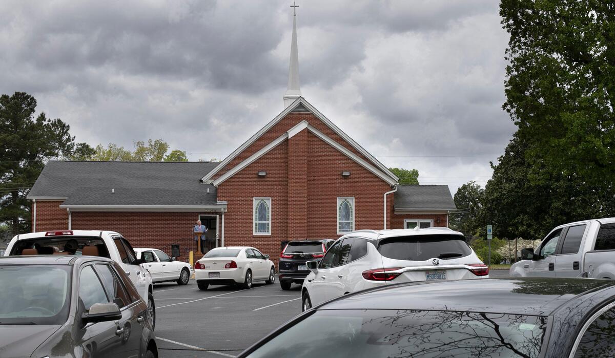 Pastor Tim Stevens delivers his Easter sermon to a drive-in congregation from the steps of the Micro First Baptist Church in Micro, N.C. on Sunday, April 12, 2020. After several weeks of broadcasting their service via Facebook due to the COVID-19 virus, the church decided to hold a drive-in service in the church’s parking lot.