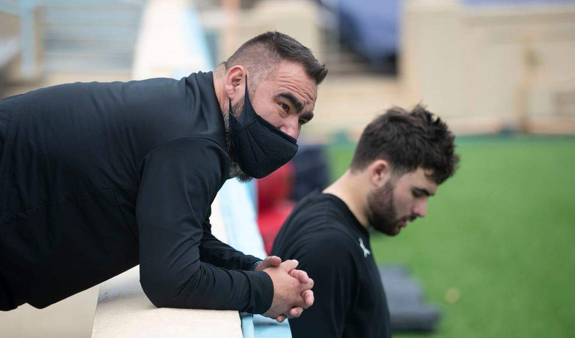 Duke Howell talks with his son, North Carolina quarterback Sam Howell following the Tar Heels’ practice on March 27 at Kenan Stadium in Chapel Hill.