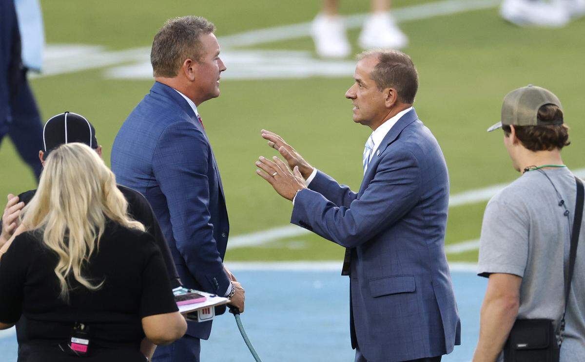 ACC Commissioner Jim Phillips talks with Kirk Herbstreit before UNC’s game against TCU at Kenan Stadium in Chapel Hill, N.C., Monday, Sept. 1, 2025.