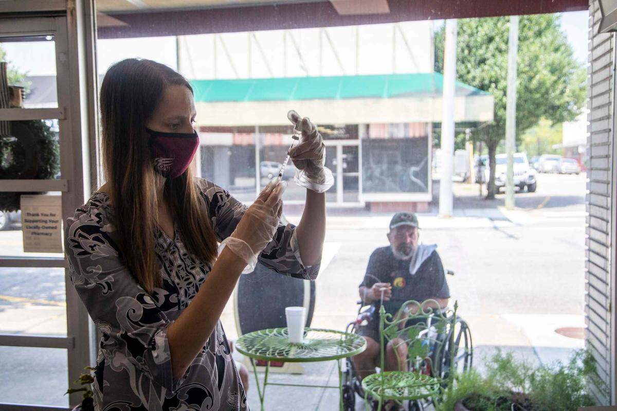 Dr. Stephanie Bellows prepares to administer a COVID-19 vaccine at Guiton’s Drug Store in Whiteville Thursday, July 29, 2021. Columbus County has the state’s highest rate for COVID-19 and one of the lowest for vaccinations. Dr. Bellows vaccinated 38 people on Thursday.