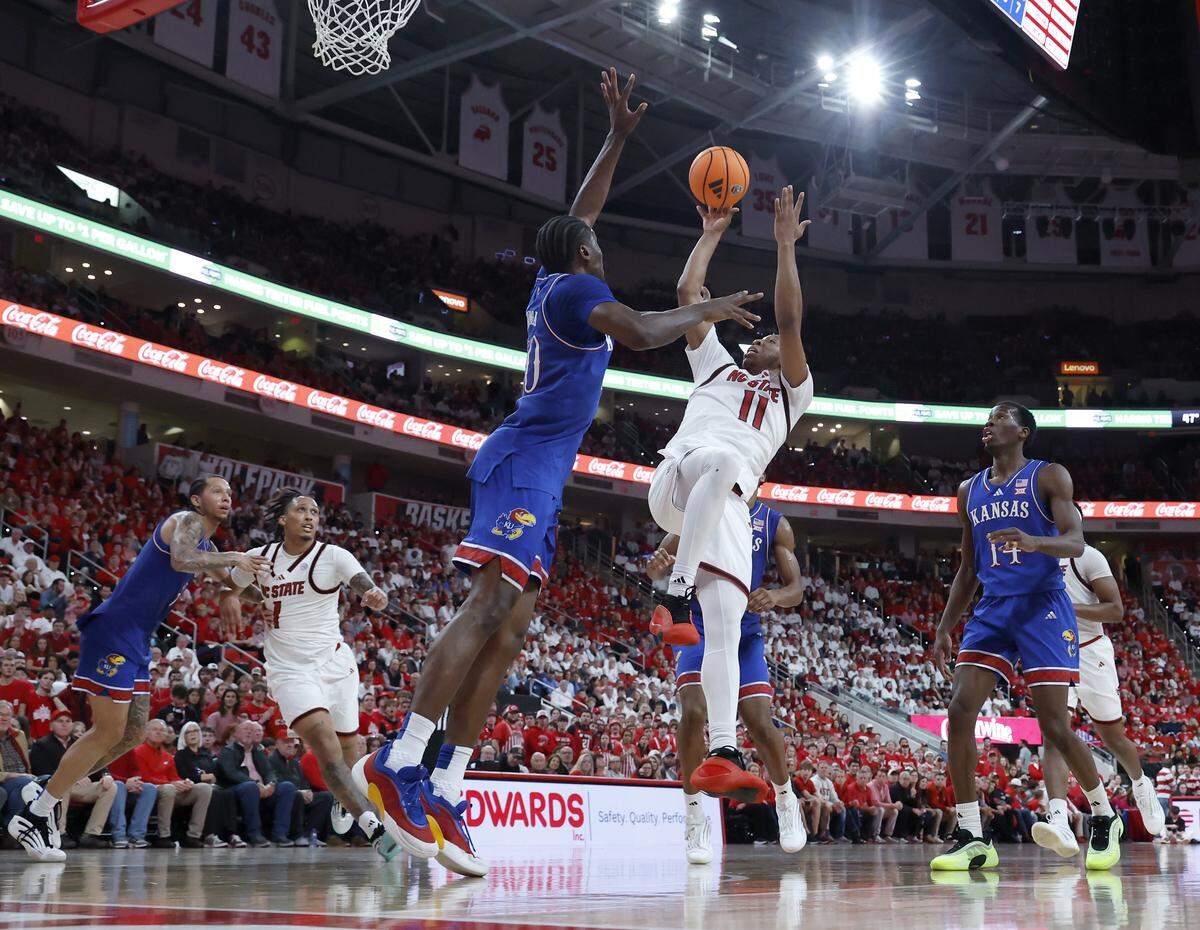 N.C. State’s Quadir Copeland shoots over Kansas’ Flory Bidunga during the second half of the Wolfpack’s 77-76 overtime loss on Saturday, Dec. 13, 2025, at Lenovo Center in Raleigh, N.C.