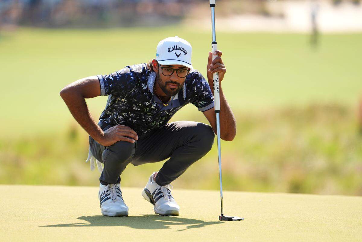 Jun 14, 2024; Pinehurst, North Carolina, USA; Akshay Bhatia lines up a putt on the 13th hole during the second round of the U.S. Open golf tournament at Pinehurst No. 2. Mandatory Credit: John David Mercer-USA TODAY Sports