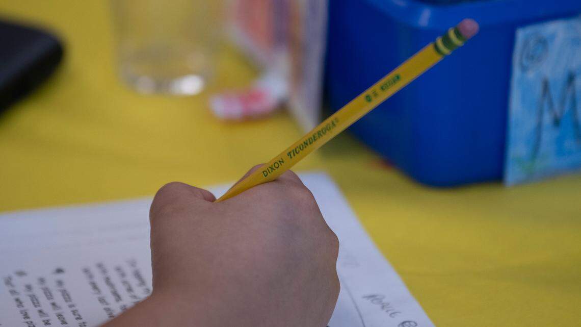 A student reviews a reading comprehension assignment in a third grade class in Wake County.