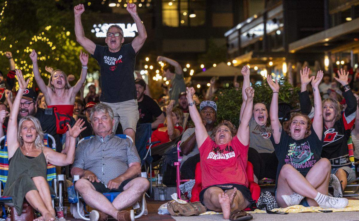 Carolina Hurricanes fans celebrate during an NHL Eastern Conference Final watch party in Raleigh's Smoky Hollow district on Friday, May 29, 2026. 