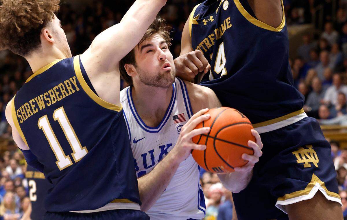 Duke’s Ryan Young (15) is defended by Notre Dame’s Braeden Shrewsberry (11), left, and Kebba Njie (14) during the first half of Duke’s game against Notre Dame at Cameron Indoor Stadium in Durham, N.C., Wednesday, Feb. 7, 2024.