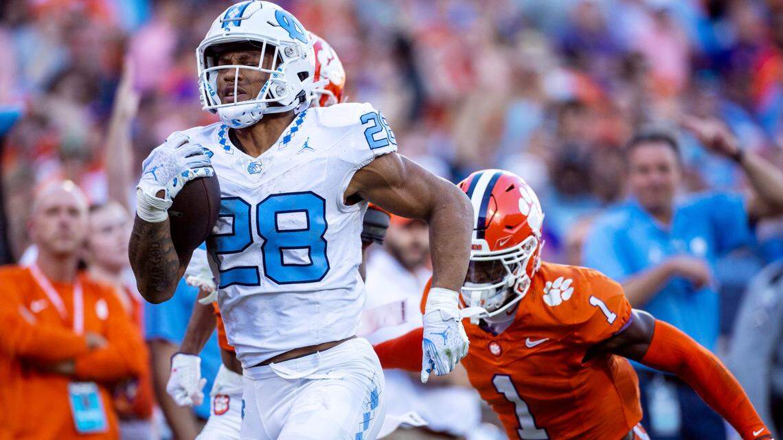 North Carolina’s Omarion Hampton (28) breaks open on a 64-yard run in the first quarter before having the ball stripped by Clemson’s Nate Wiggins (2) on Saturday, November 18, 2023 at Memorial Stadium in Clemson, S.C.