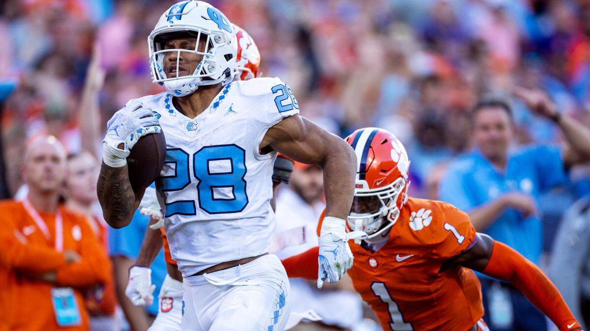 North Carolina’s Omarion Hampton (28) breaks open on a 64-yard run in the first quarter before having the ball stripped by Clemson’s Nate Wiggins (2) on Saturday, November 18, 2023 at Memorial Stadium in Clemson, S.C.