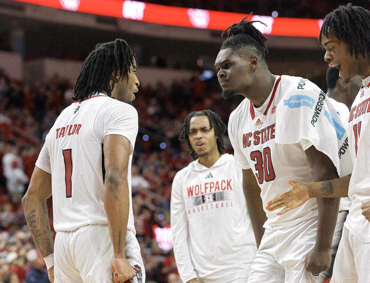 N.C. State’s DJ Burns Jr. (30) celebrates with Jayden Taylor following a breakaway dunk during the second half of the Wolfpack’s 82-76 win over Georgia Tech on Saturday, Feb. 3, 2024, at PNC Arena in Raleigh, N.C.