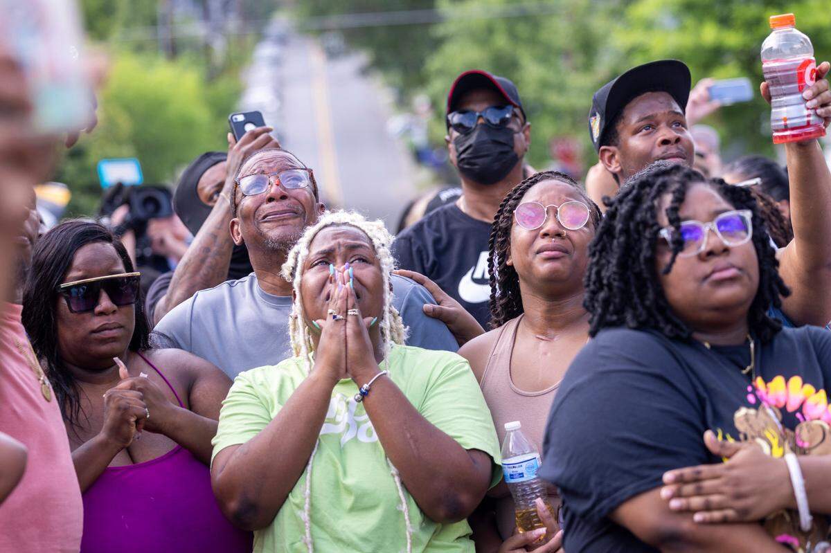 Brittany Dash, the mother of 5-year-old Khloe Fennell, left, watches with family, friends and neighbors as balloons drift away during a vigil Friday, July 7, 2023 in Durham. Fennell was shot and killed on Wednesday. Her 15-year-old cousin was babysitting her. She was shot multiple times and survived.