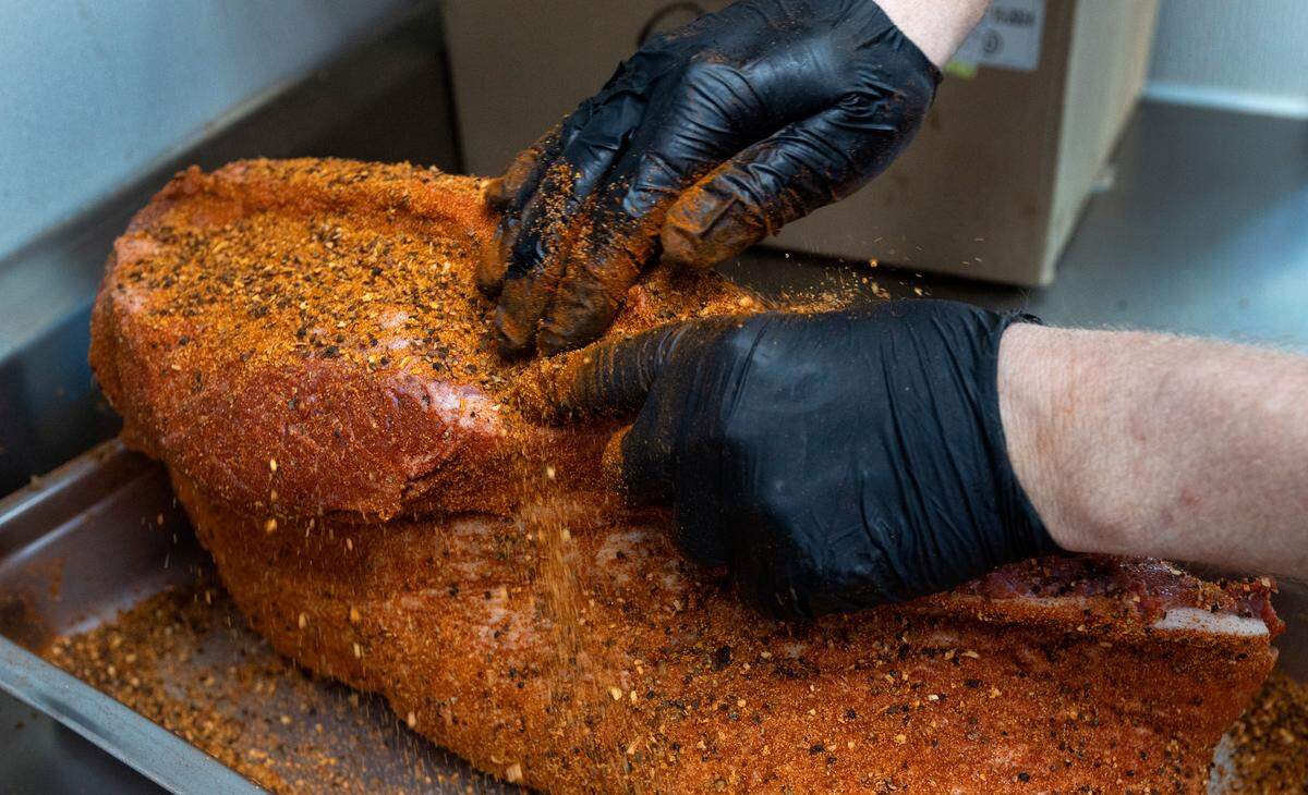 Pitmaster Matt Barry seasons brisket at Midwood Smokehouse in Raleigh, N.C., Wednesday, Feb. 8, 2023.