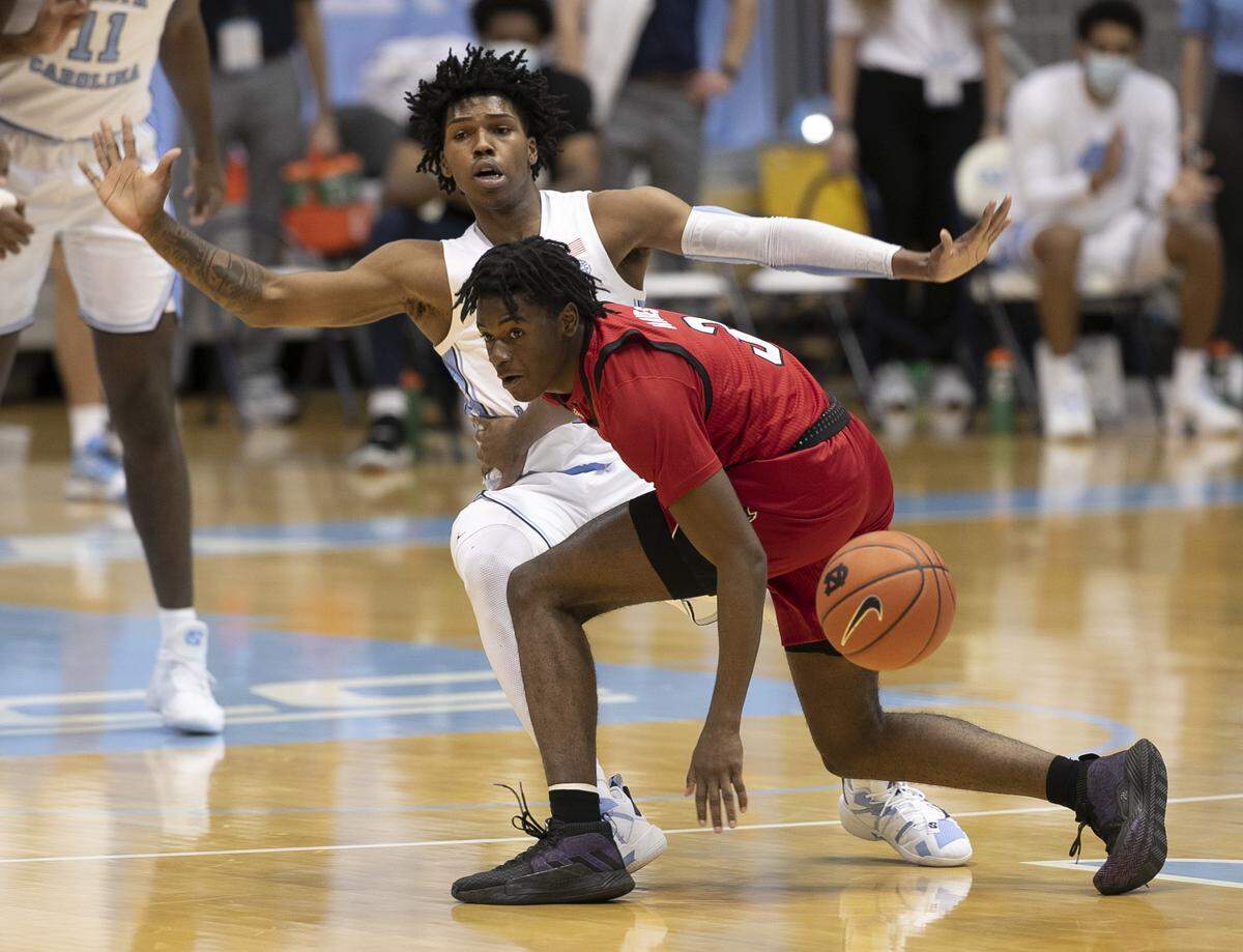 North Carolina’s Caleb Love (2) defends N.C. State’s Cam Hayes (3) during the first half on Saturday, January 23, 2021 at the Smith Center in Chapel Hill, NC.