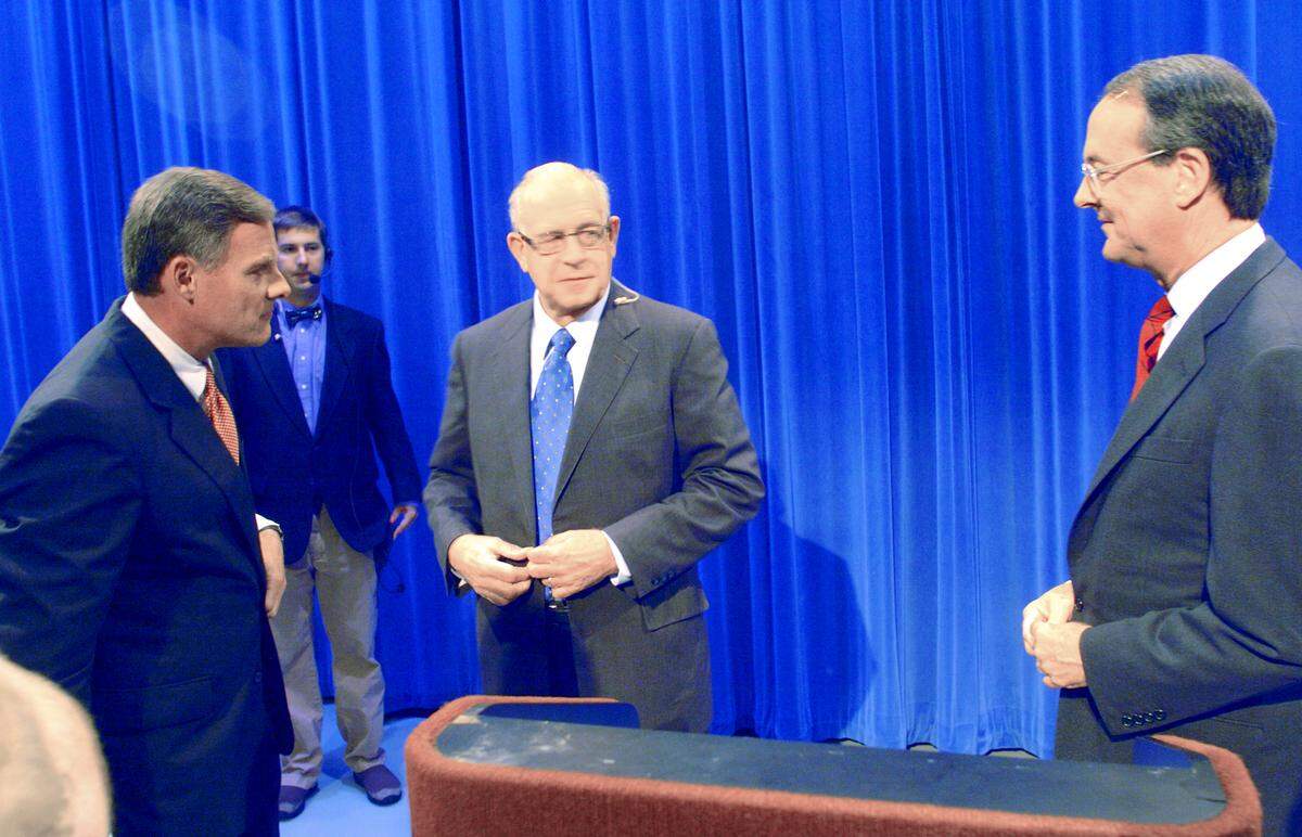 Republican candidate for US senate Richard Burr, left, and Democratic candidate Erskine Bowles, right, greet each other before a debate held at UNC -TV studios in RTP in 2004.  Moderator Carl Kasell is in the center.