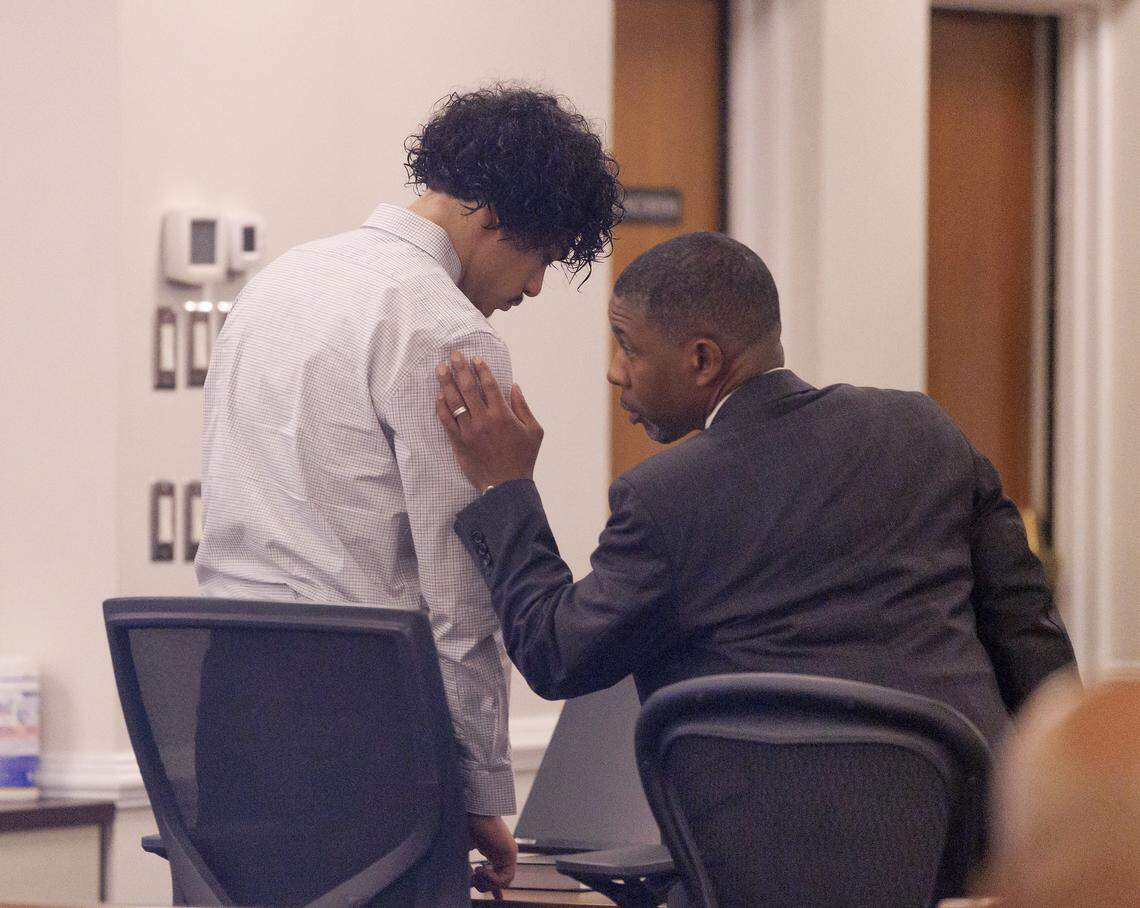 Issiah Ross, who is accused of fatally shooting two teenagers in Orange County in 2022, talks with his attorney, Jonathan Trapp, in a courtroom at the Orange County Courthouse on Monday, Jan. 12, 2026, in Hillsborough, N.C.