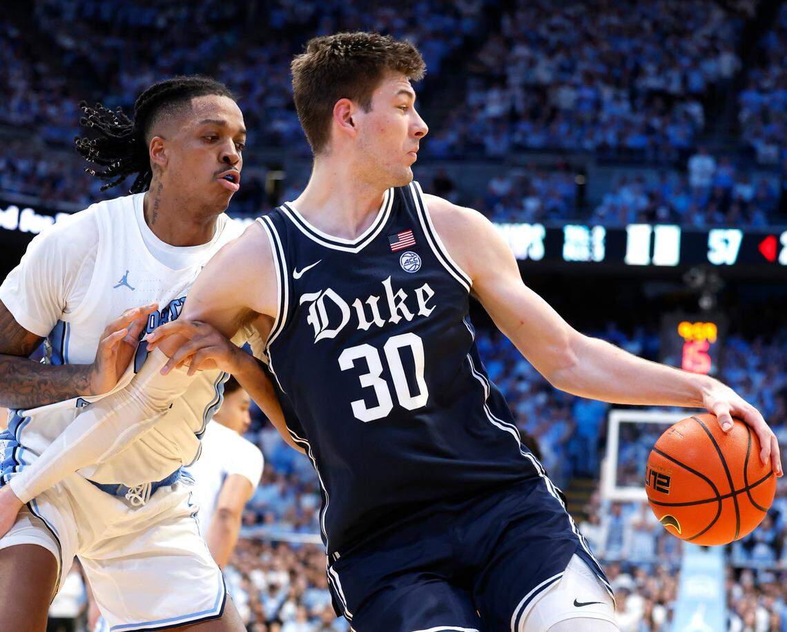Duke’s Kyle Filipowski (30) tries to work around North Carolina’s Armando Bacot (5) during the second half of UNC’s 93-84 victory over Duke at the Smith Center in Chapel Hill, N.C., Saturday, Feb. 3, 2024.