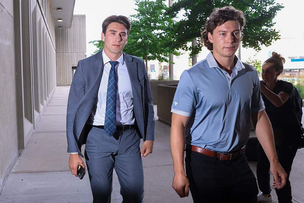LONDON, CANADA - JULY 24: Michael McLeod, left, arrives at the London Courthouse, in London, Ontario, Canada on July 24, 2025. Former world junior hockey players Dillon DubÃ©, Cal Foote, Alex Formenton, Carter Hart and Michael McLeod, have all pleaded not guilty to a sexual assault that allegedly occurred at a London hotel in June 2018 as the team was celebrating their world championship win months earlier. (Photo by Cole Burston/Getty Images)