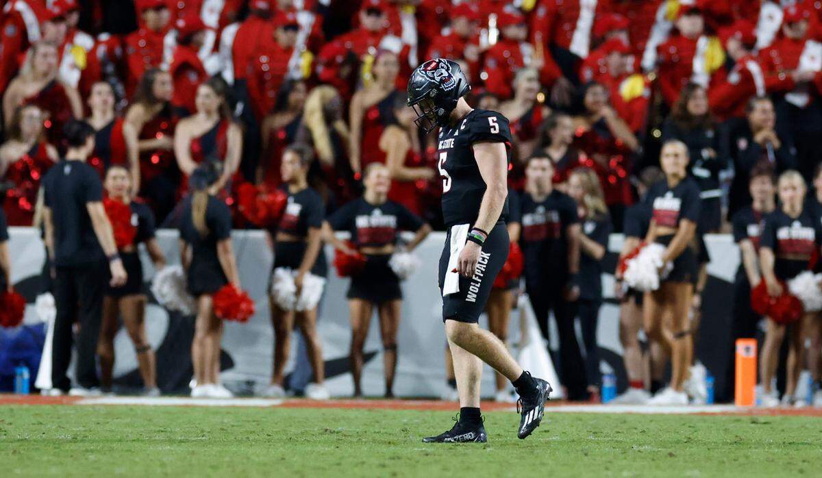 N.C. State quarterback Brennan Armstrong (5) walks off the field after throwing an interception in the final minute of Louisville’s 13-10 victory over N.C. State at Carter-Finley Stadium in Raleigh, N.C., Friday, Sept. 29, 2023.